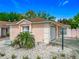 Charming single-story home featuring a well-maintained yard with decorative rock and small palm tree at 1711 Francisco St, The Villages, FL 32159