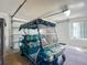 Garage featuring a golf cart and door access to the home at 1711 Francisco St, The Villages, FL 32159