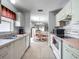 Efficient kitchen with white appliances, view to open concept dining and living space at 1711 Francisco St, The Villages, FL 32159