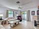 Inviting living room with tile floors, neutral paint, a ceiling fan, and sliding glass doors to the outside at 1711 Francisco St, The Villages, FL 32159
