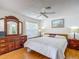 Bright main bedroom featuring a ceiling fan, hardwood floors, and plenty of natural light at 1711 Francisco St, The Villages, FL 32159