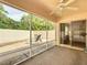 Large screened patio with ceiling fan and outdoor seating area at 1711 Francisco St, The Villages, FL 32159