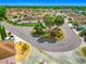 Street view of a charming neighborhood featuring well-kept homes, lush landscaping, and a roundabout at 1711 Francisco St, The Villages, FL 32159