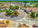 Street view featuring well-maintained homes, manicured landscaping, and a cul-de-sac with mature palm trees at 1711 Francisco St, The Villages, FL 32159
