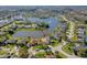 This aerial view shows the home nestled in a lakeside community with mature landscaping and serene water views at 1792 Arash Cir, Port Orange, FL 32128