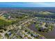 Scenic aerial view of homes nestled around a beautiful lake and lush greenery in a desirable community at 1792 Arash Cir, Port Orange, FL 32128