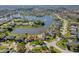Picturesque aerial view of a waterfront community with homes surrounding a serene lake with a fountain at 1792 Arash Cir, Port Orange, FL 32128