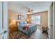 This bedroom features wood-look flooring and a ceiling fan, with natural light from the window at 1792 Arash Cir, Port Orange, FL 32128