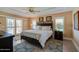 A primary bedroom is bright with plantation shutters, a trey ceiling, and an ensuite bathroom at 1792 Arash Cir, Port Orange, FL 32128