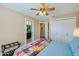 This bedroom boasts a ceiling fan, closet space and an ensuite bathroom at 1792 Arash Cir, Port Orange, FL 32128