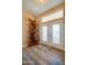 A bright entryway features beautiful wood-look floors, an art niche and double doors with window panes at 1792 Arash Cir, Port Orange, FL 32128