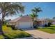 Charming single-story home with a well-manicured lawn, mature trees, and a two-car garage at 1792 Arash Cir, Port Orange, FL 32128