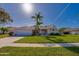 Inviting single-story home boasts lush landscaping, mature palms, and a two-car garage at 1792 Arash Cir, Port Orange, FL 32128