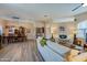 Open-concept living room with wood floors is full of natural light and stylish furnishings at 1792 Arash Cir, Port Orange, FL 32128