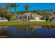 Rear exterior of home showcasing pool and screened in patio overlooking a pond at 1792 Arash Cir, Port Orange, FL 32128