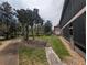 Backyard with screened patio overlooking the lush landscaped grounds with mature trees and a walking path at 190 Hickory Woods Ct # 15C, Deltona, FL 32725