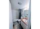 The updated bathroom has a shower and tub combination, white cabinets and tile floors at 190 Hickory Woods Ct # 15C, Deltona, FL 32725