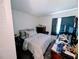 Comfortable bedroom with a double bed, dresser, and curtains, creating a relaxing personal space at 190 Hickory Woods Ct # 15C, Deltona, FL 32725