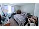 Bedroom with a purple comforter and decorations including a sewing machine and various decorations at 190 Hickory Woods Ct # 15C, Deltona, FL 32725