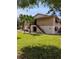 Charming two-story condo with palm trees, well-manicured lawn, and inviting entryway stairs at 190 Hickory Woods Ct # 15C, Deltona, FL 32725