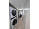 Hallway with washer and dryer combination appliance, white walls, and tile floors at 190 Hickory Woods Ct # 15C, Deltona, FL 32725