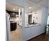 Modern kitchen with granite countertops, white cabinets, and open layout at 190 Hickory Woods Ct # 15C, Deltona, FL 32725