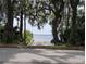 Picturesque waterfront view through the trees revealing a tranquil beach and peaceful lake at 190 Hickory Woods Ct # 15C, Deltona, FL 32725