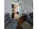 Comfortable living room with hardwood floors, gray sofas, and view of entryway at 190 Hickory Woods Ct # 15C, Deltona, FL 32725