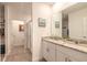 Bright bathroom with dual sinks, granite counters, white cabinets, tiled floors, and a glass door shower, creating a luxurious space at 207 Pitching Wedge Dr, Daytona Beach, FL 32124