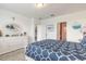 Serene bedroom featuring a white dresser, soft carpet, and a comfortable bed with stylish blue and white bedding at 207 Pitching Wedge Dr, Daytona Beach, FL 32124