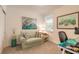 Comfortable bedroom with neutral carpet, large window and a cozy seating area perfect for reading or relaxing at 207 Pitching Wedge Dr, Daytona Beach, FL 32124