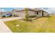 Charming single-story home with a well-manicured lawn, landscaped garden, and a brick-paved driveway at 207 Pitching Wedge Dr, Daytona Beach, FL 32124