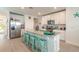 Bright kitchen featuring white cabinets, granite countertops, stainless steel appliances, and a center island at 207 Pitching Wedge Dr, Daytona Beach, FL 32124