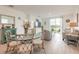 Open-concept living area with dining space, stylish decor, and a sliding glass door leading to the backyard at 207 Pitching Wedge Dr, Daytona Beach, FL 32124