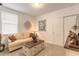 Cozy living room featuring comfortable seating, neutral carpet, a decorative table, and natural light from a window at 207 Pitching Wedge Dr, Daytona Beach, FL 32124