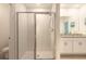 Modern bathroom featuring a glass-enclosed shower with tile surround, complemented by a vanity with granite counters and white cabinets at 207 Pitching Wedge Dr, Daytona Beach, FL 32124