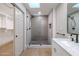 Bright bathroom featuring a sleek, glass enclosed shower, linen closet and skylight above at 210 Sage Brush Trl, Ormond Beach, FL 32174