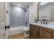 Stylish bathroom featuring decorative tile, a bathtub and modern vanity with marble top at 210 Sage Brush Trl, Ormond Beach, FL 32174
