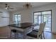Dining room with a modern light fixture, wood-look floors, and sliding glass door access to the lanai at 210 Sage Brush Trl, Ormond Beach, FL 32174