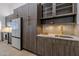Sleek kitchen featuring stainless steel appliances, wood cabinets with gold pulls, and spacious counters at 210 Sage Brush Trl, Ormond Beach, FL 32174