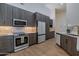 Kitchen showcasing stainless steel appliances, wood cabinets, and sleek countertops at 210 Sage Brush Trl, Ormond Beach, FL 32174