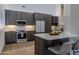 Modern kitchen boasts wood cabinets, stainless steel appliances, and a center island with seating at 210 Sage Brush Trl, Ormond Beach, FL 32174