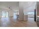 Bright living area with sliding glass doors, wood-look floors, and a view into the dining and kitchen areas at 210 Sage Brush Trl, Ormond Beach, FL 32174