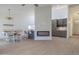 Spacious living area featuring wood-look floors, bar seating, fireplace, and access to the dining area at 210 Sage Brush Trl, Ormond Beach, FL 32174