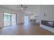 Open floorplan with wood-look floors, fireplace, and sliding doors to the outdoor patio at 210 Sage Brush Trl, Ormond Beach, FL 32174