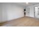 Spacious main bedroom with wood-look floors, a doorway to the ensuite bathroom, and plenty of room at 210 Sage Brush Trl, Ormond Beach, FL 32174