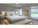 Staged main bedroom showcasing natural light and a calm aesthetic with soft colors at 210 Sage Brush Trl, Ormond Beach, FL 32174