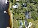 Overhead aerial perspective of elegant waterfront homes with private docks, swimming pools, and sprawling green lawns at 2149 Hontoon Rd, Deland, FL 32720