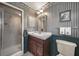 Elegant bathroom featuring a glass shower, vintage-themed wallpaper, and charming decorative touches at 2149 Hontoon Rd, Deland, FL 32720