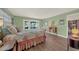 Bright bedroom with hardwood floors and doors leading to the pool area at 2149 Hontoon Rd, Deland, FL 32720